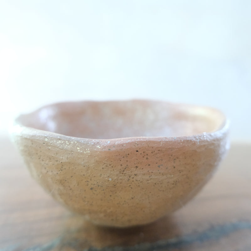 Micaceous clay earthenware tea bowl by The New New Age. 