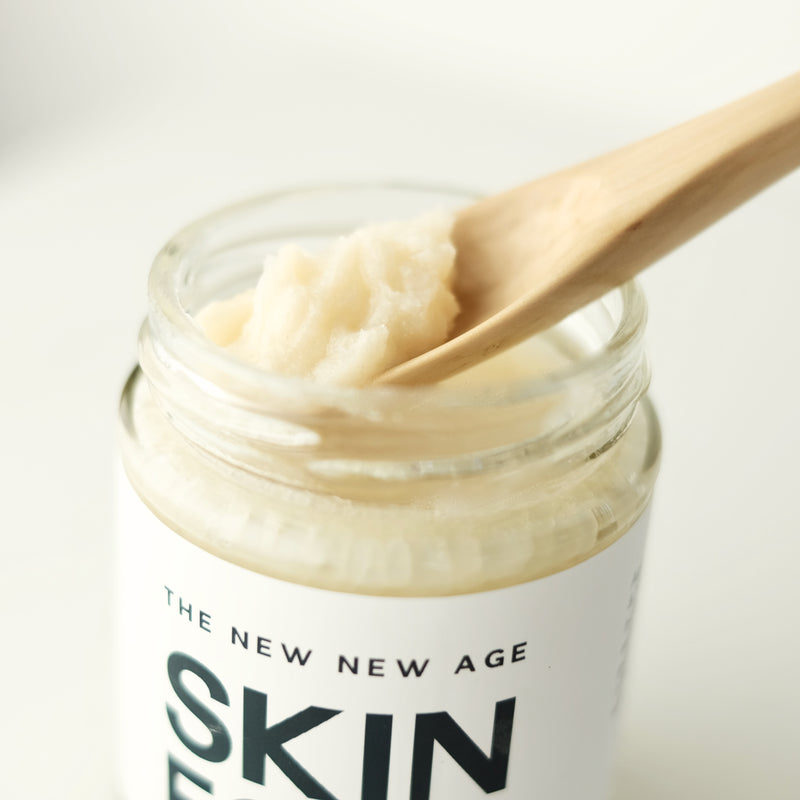 A jar of Skin Food, made of organic virgin coconut oil, raw cacao butter and unrefined, treatment-free beeswax. Formulated by The New New Age.