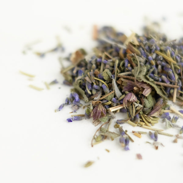 A close up of organic herbal tea, featuring sage, rosemary, lavender, lemongrass. This tea is called Mind Magic and is made by The New New Age.